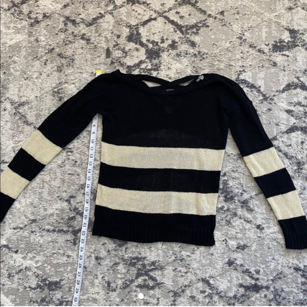 Cream and black colored sweater